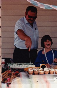 Dad trying to cut a birthday cake I made for him. I frosted a cardboard box.